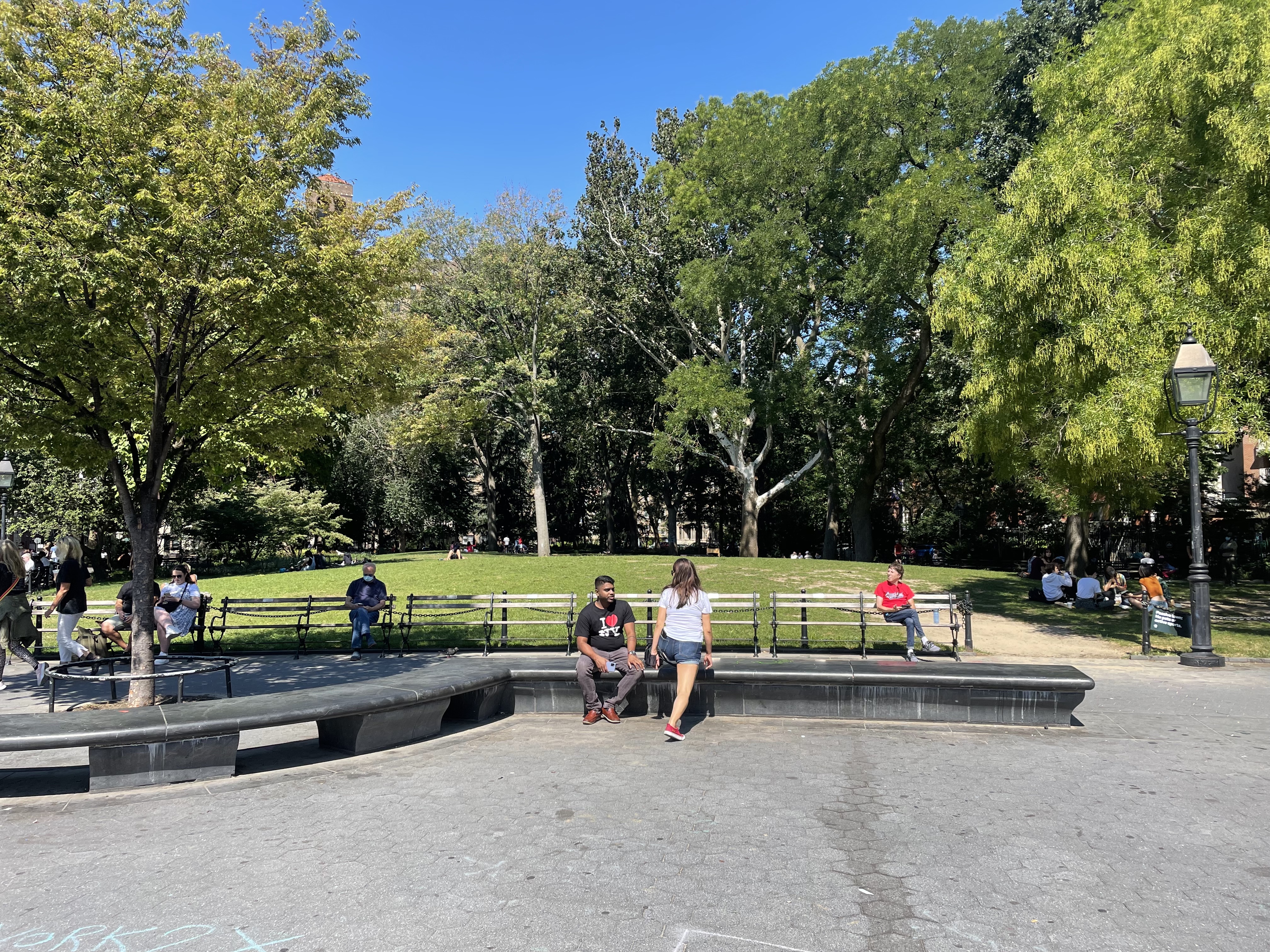Stone and wooden benches in Washington Square Park