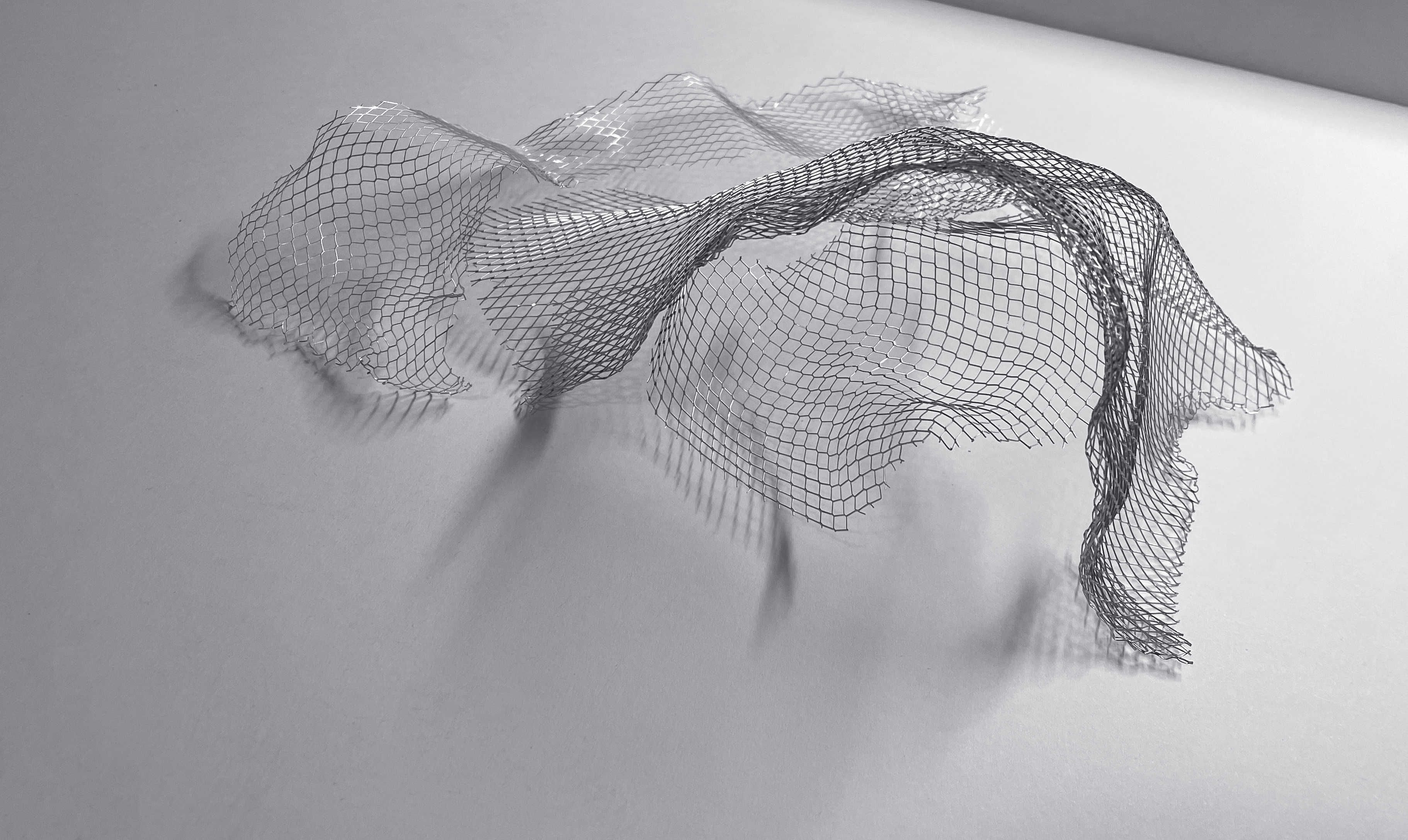Wire model of seat with a covering over it and a second seat to its right